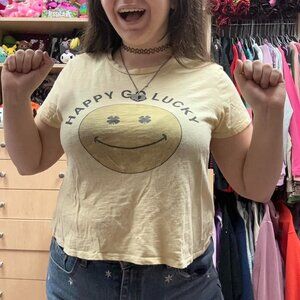 yellow crop top with "happy go lucky" design !!